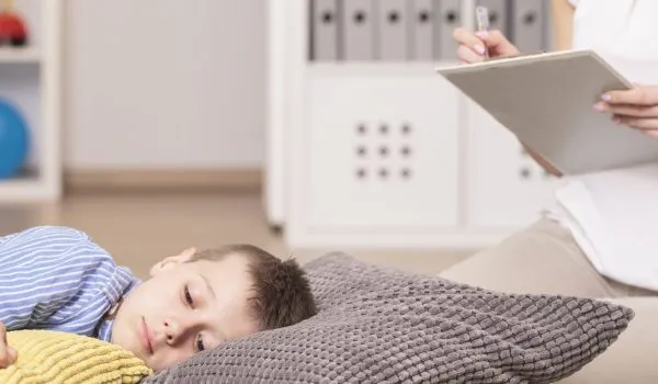 Autistic boy lying on pillows Women Analysing Kid's Health